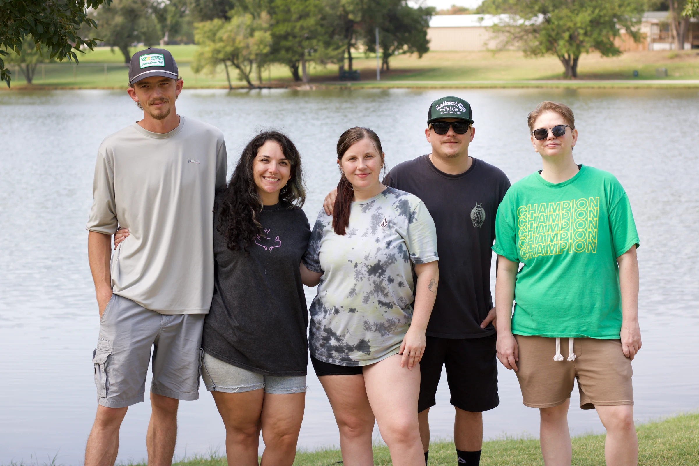 Gang Green and their tech captain pose together by the lake.